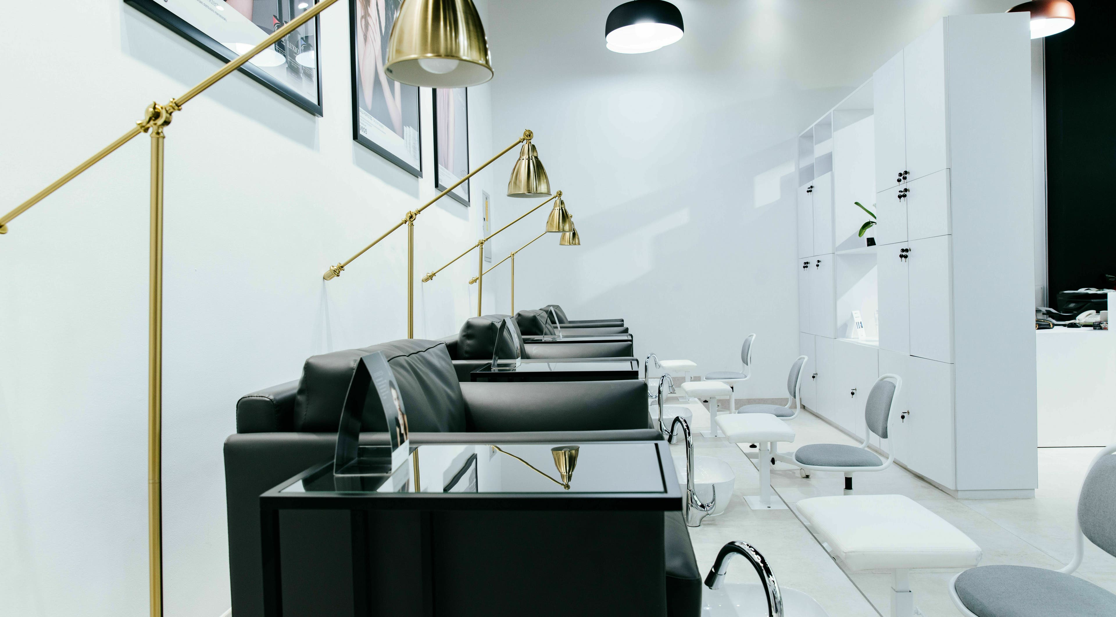 Luxio Nail Ladies Salon in Dubai, AE, showcasing sleek black chairs and gold lamps in a modern, tranquil setting.