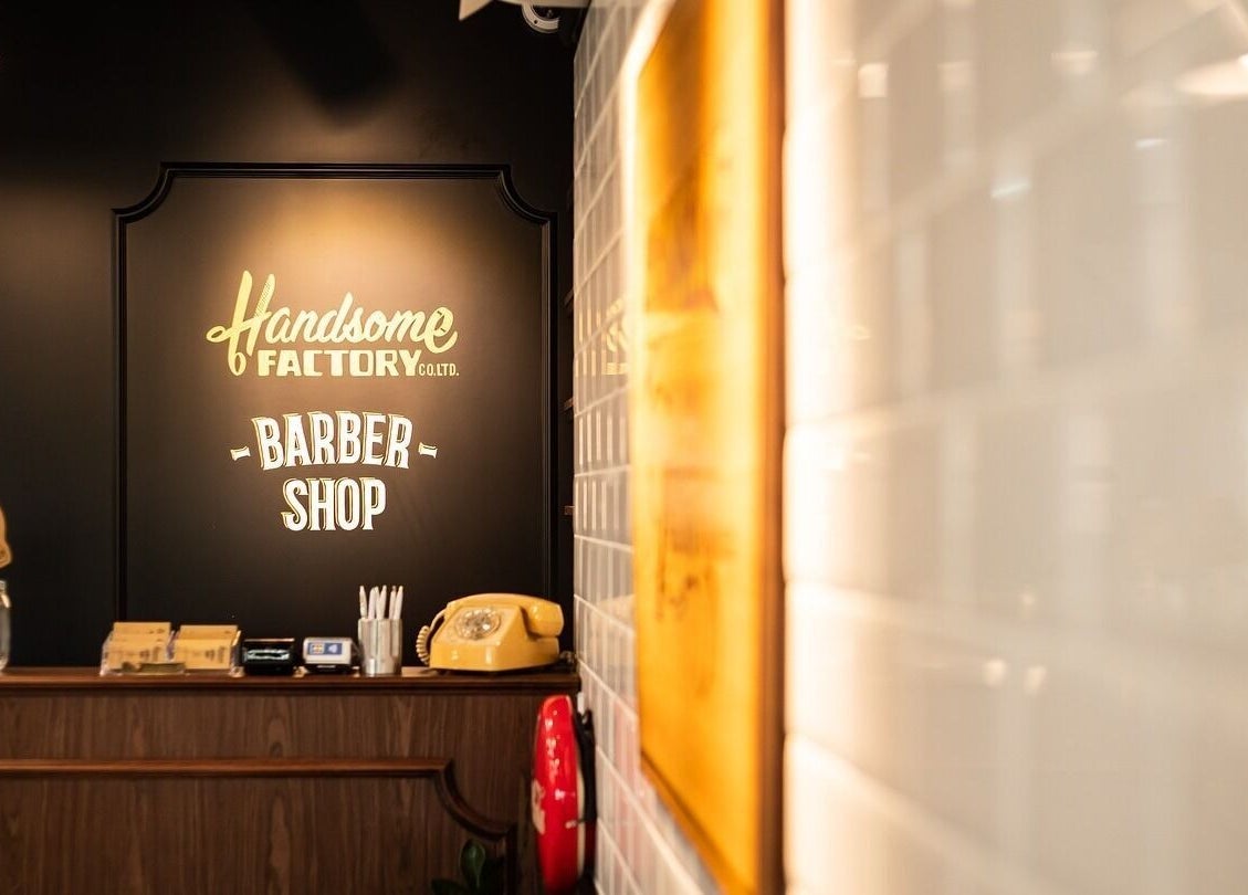 Interior of Tsim Sha Tsui | Handsome Factory Barber Shop in Kowloon, HK with retro decor and signage.