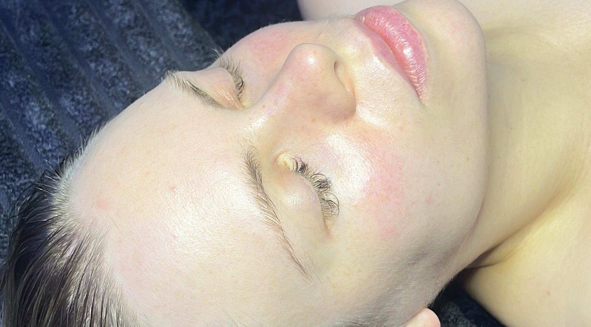 Close-up of a woman's radiant face post-treatment at Spasthetics, Newcastle-under-Lyme, England, GB.
