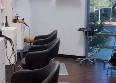 Modern interior of The Curl Studio, Las Vegas, Nevada, US with stylish styling chairs and sleek design.