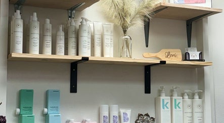 Product shelves at Uninhibited Curls by Lori Peppin Hair, showcasing haircare items in Lubbock, Texas, US.