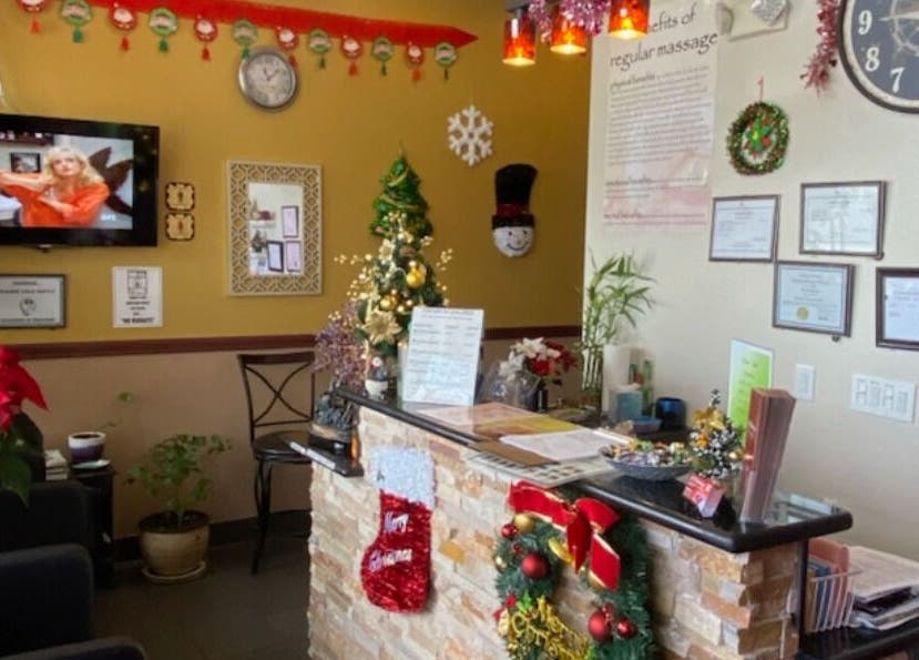 AJ Reflexology reception decorated for the holidays in Gilbert, Arizona, US, with Christmas ornaments and plants.