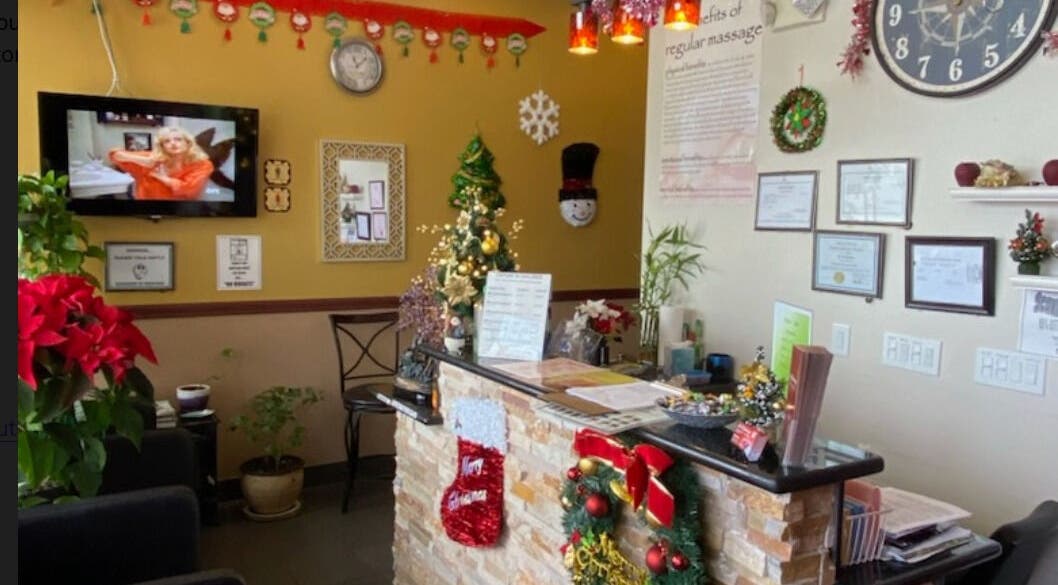 AJ Reflexology reception decorated for the holidays in Gilbert, Arizona, US, with Christmas ornaments and plants.