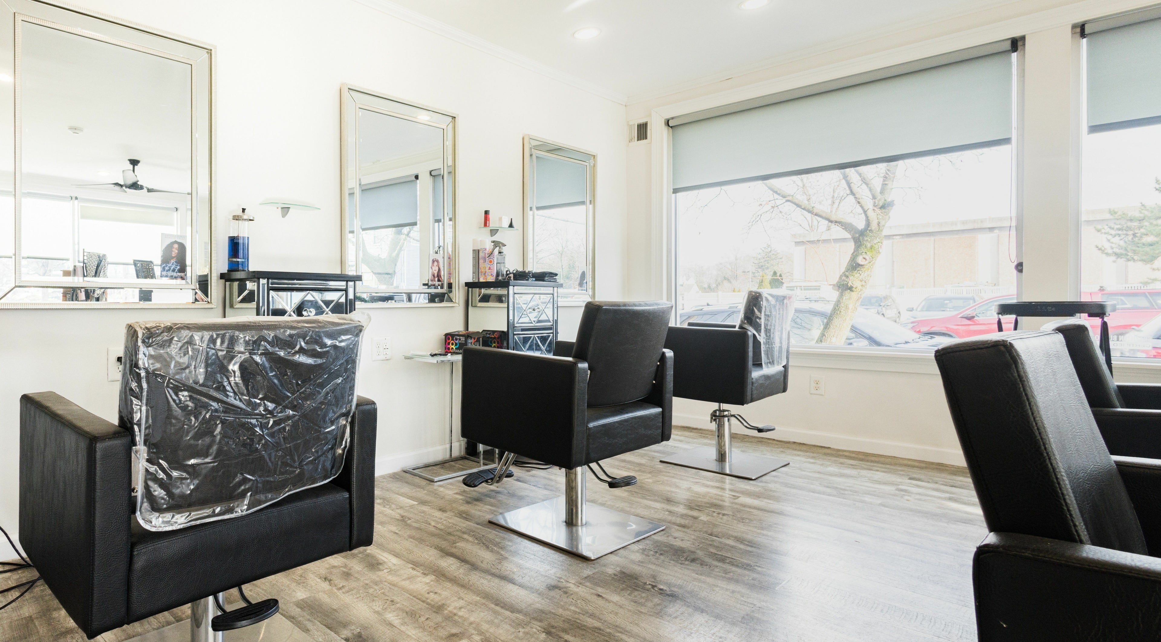 Interior of GC Hair Salon with modern black chairs in New City, New York, US.