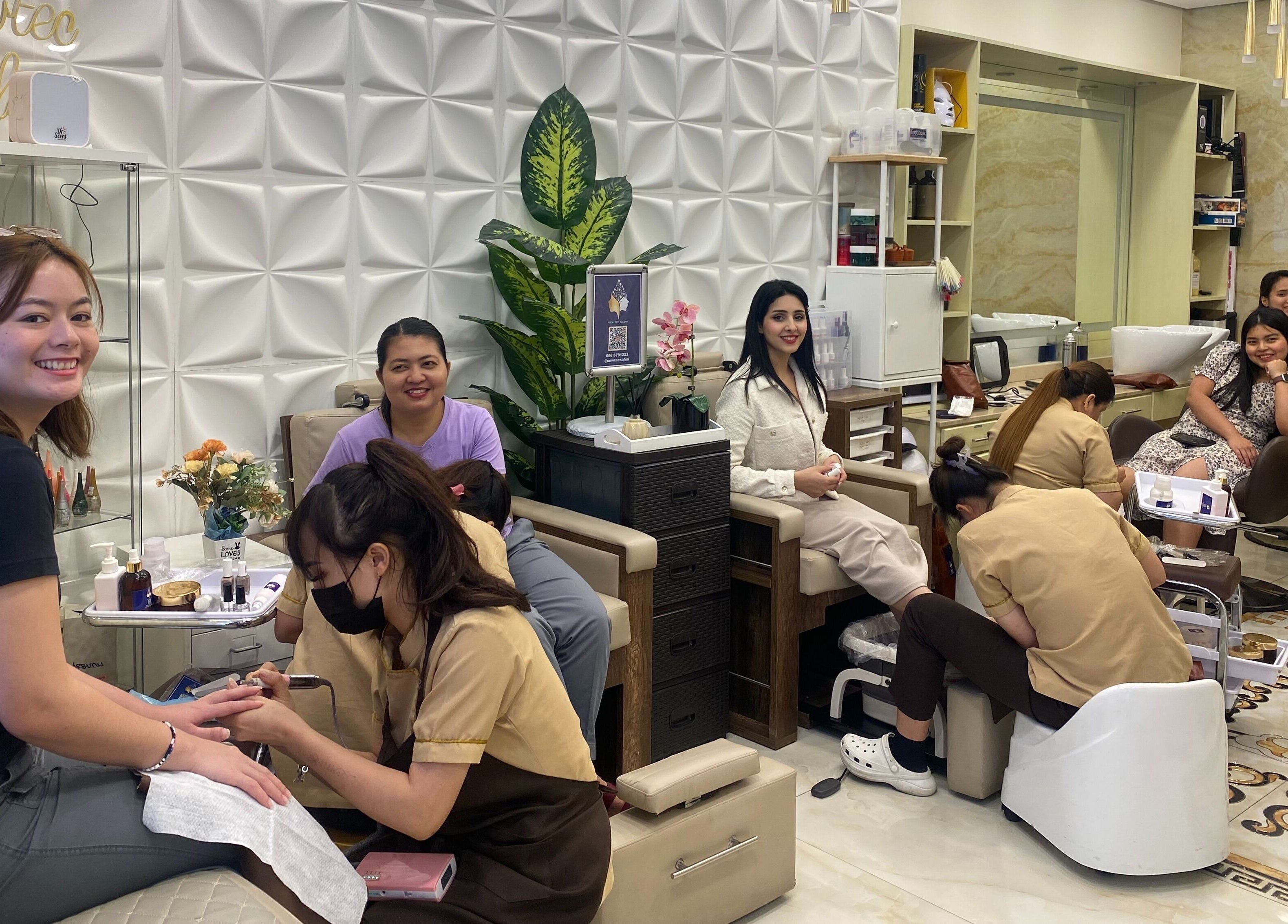 Clients enjoying relaxing manicures at New Tec Saloon, Dubai, Dubai, AE in a luxurious setting.