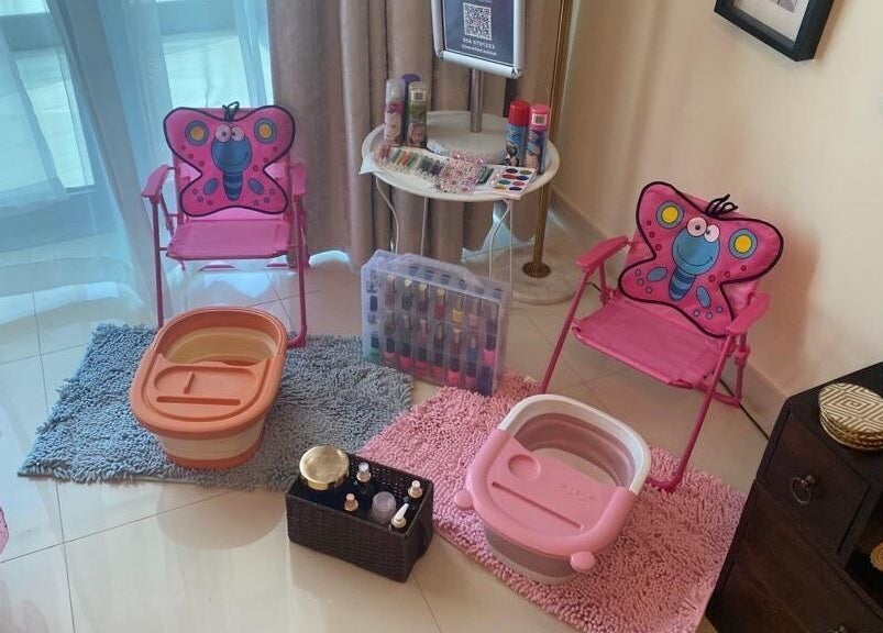 Cozy kids' pedicure setup at New Tec Saloon, Dubai, Dubai, AE featuring butterfly chairs and foot spas.