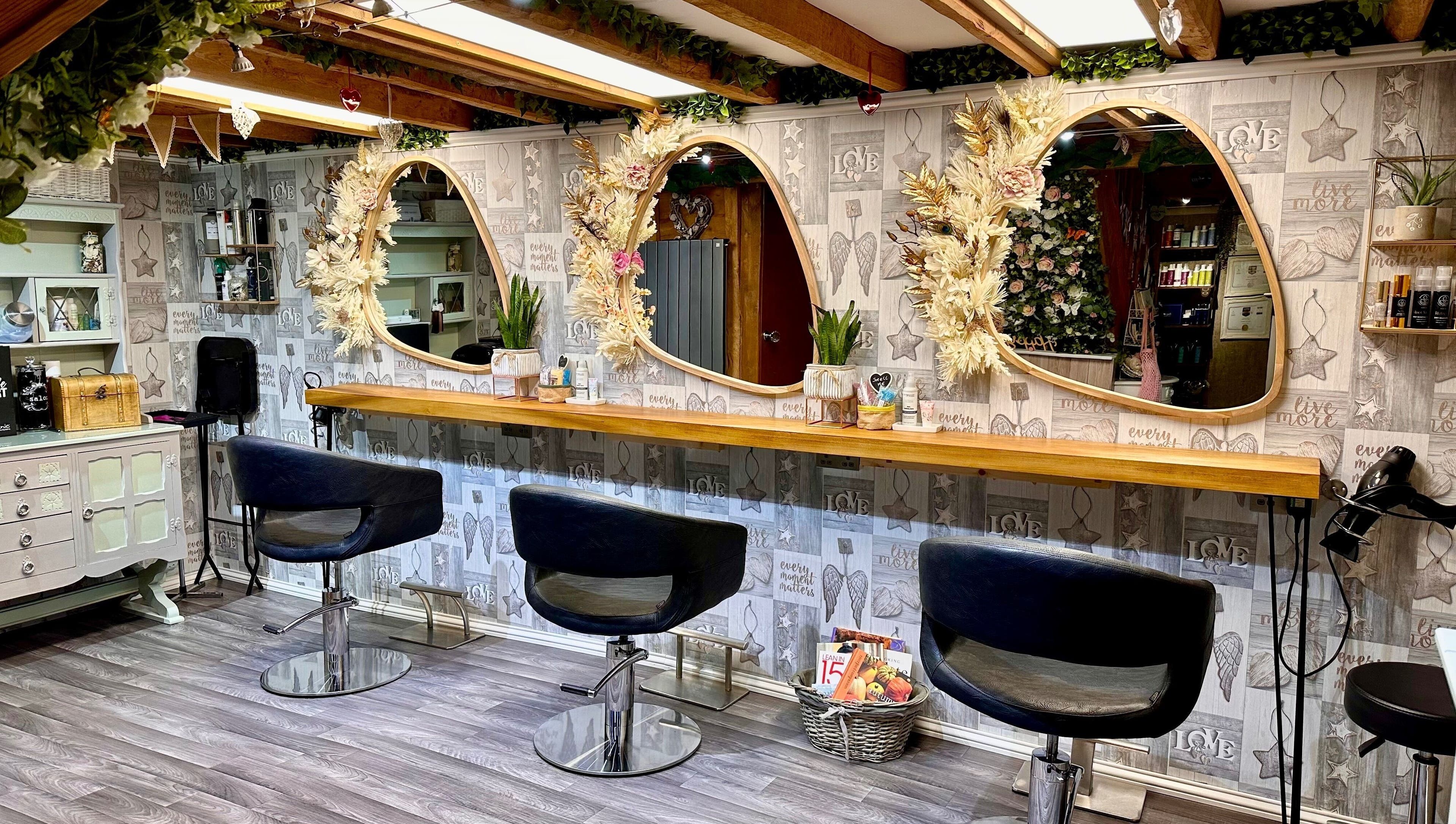 Elegant interior of Hair By Carla salon in Salisbury, England, GB with stylish mirrors and cozy seating.