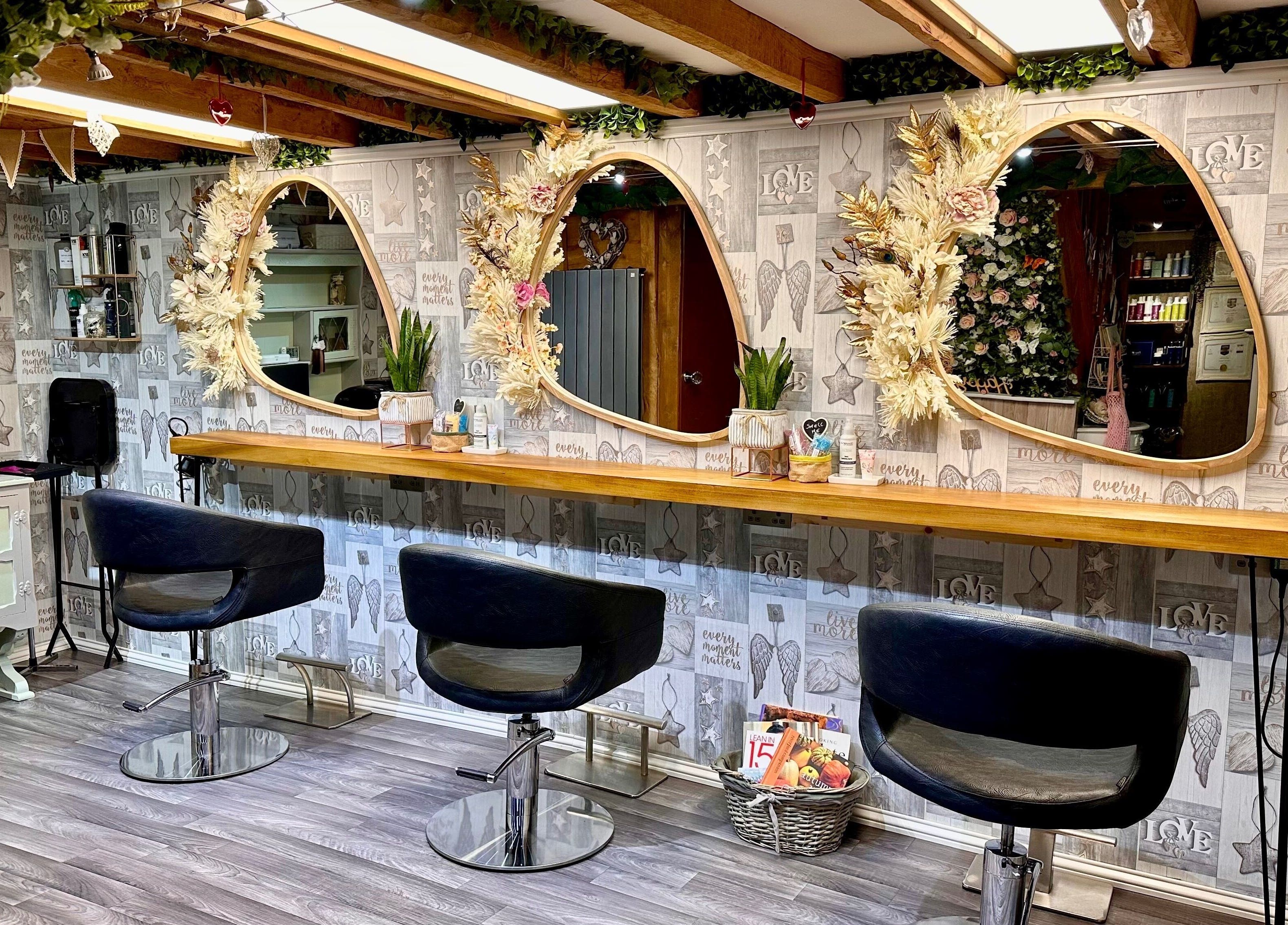 Elegant interior of Hair By Carla salon in Salisbury, England, GB with stylish mirrors and cozy seating.