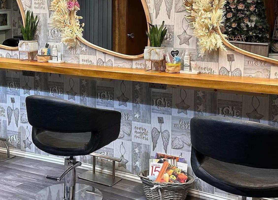 Stylish salon chairs and decorative mirrors inside Hair By Carla, Salisbury, England, GB.