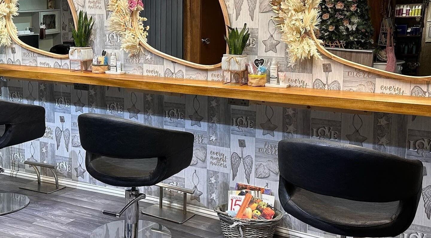 Stylish salon chairs and decorative mirrors inside Hair By Carla, Salisbury, England, GB.
