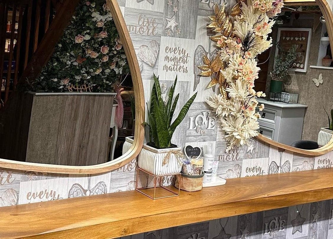 Elegant decor mirror at Hair By Carla, Salisbury, England, GB, featuring floral and plant accents.