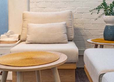 Comfortable seating area at Thammarat Thai Massage in Ponsonby, Auckland, NZ, featuring soft beige chairs.