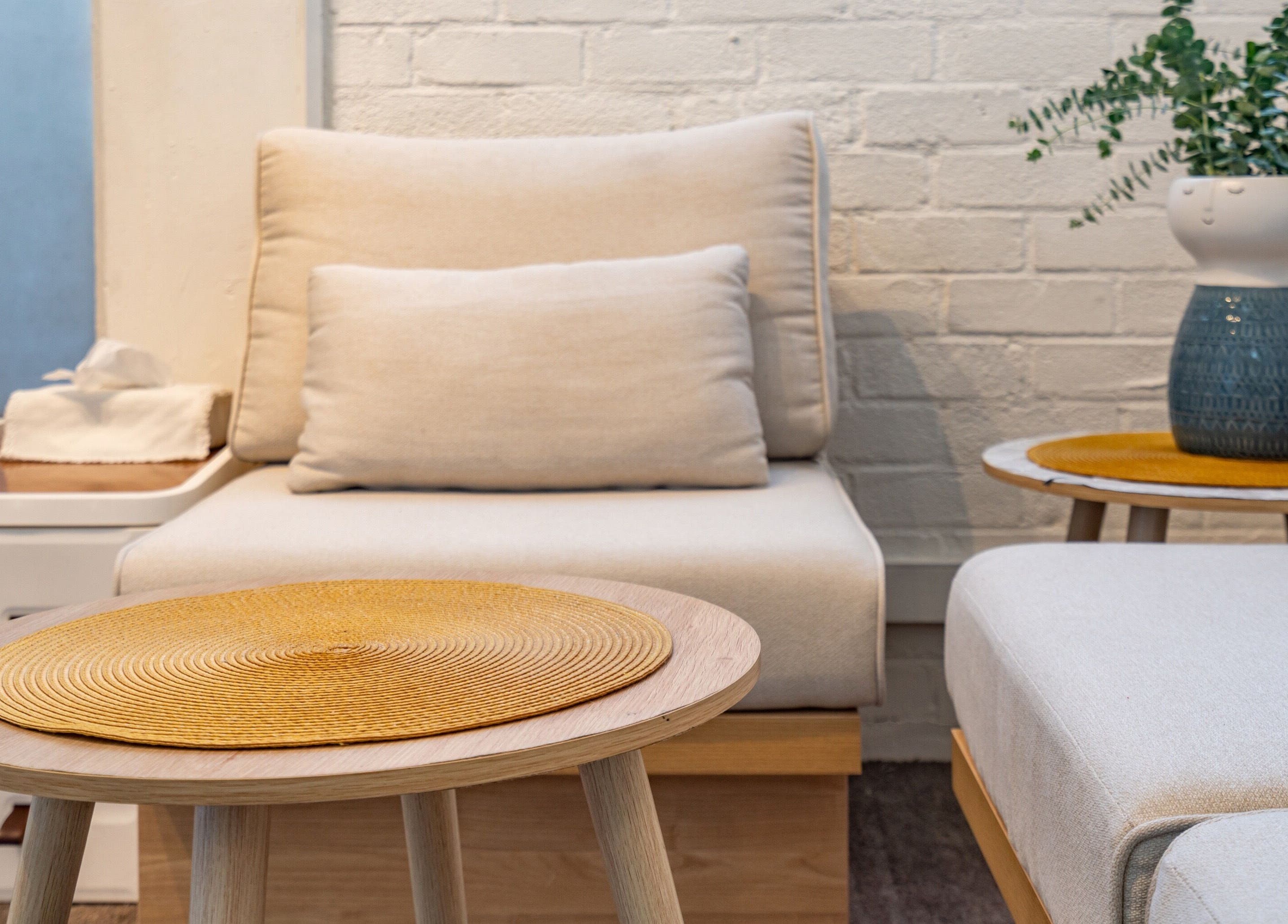 Comfortable seating area at Thammarat Thai Massage in Ponsonby, Auckland, NZ, featuring soft beige chairs.