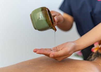 Massage therapist pouring oil at Thammarat Thai Massage in Ponsonby, Auckland, Auckland, NZ.