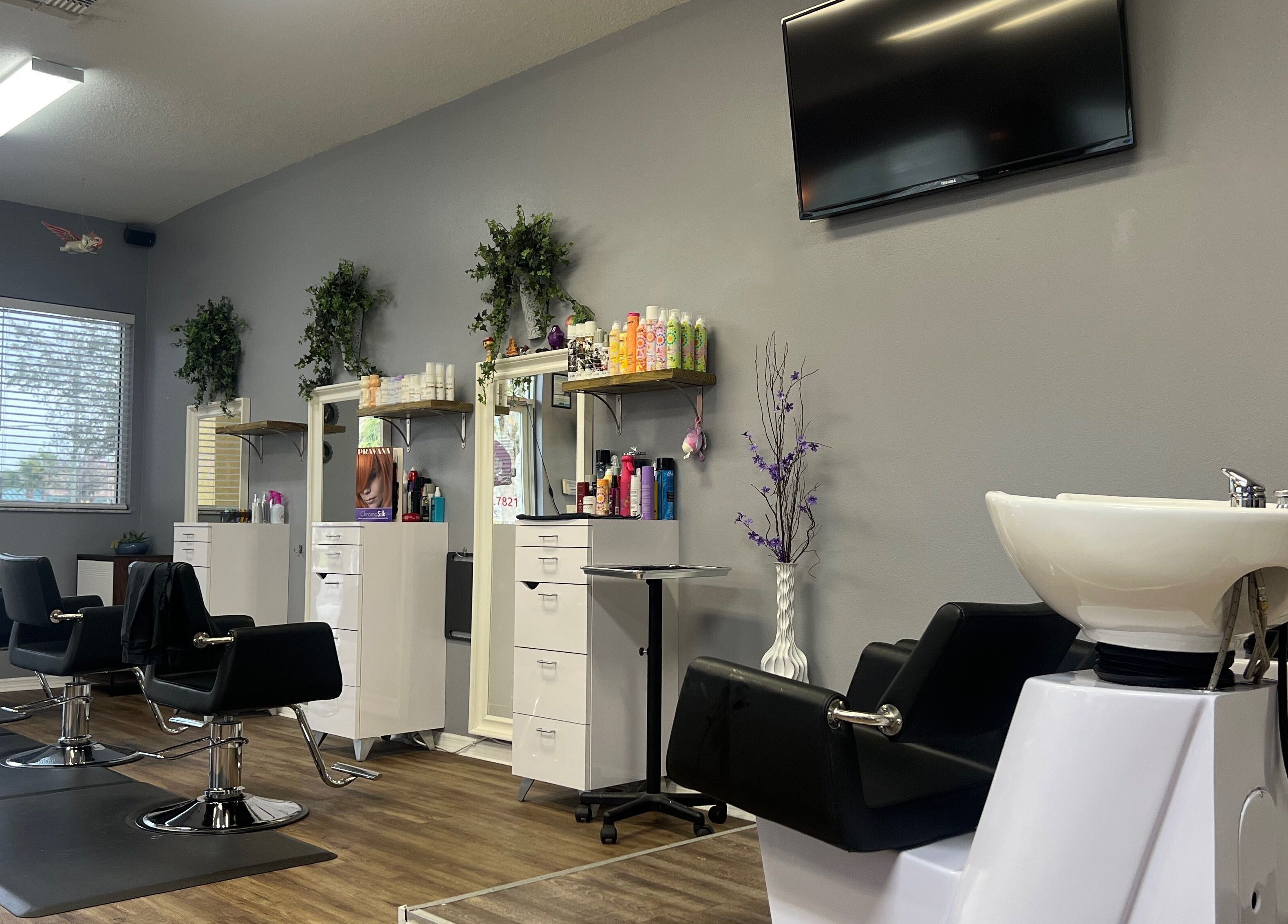 Stylish interior of Beauty Radio Salon in Zephyrhills, Florida, US, showcasing sleek styling chairs and vibrant decor.