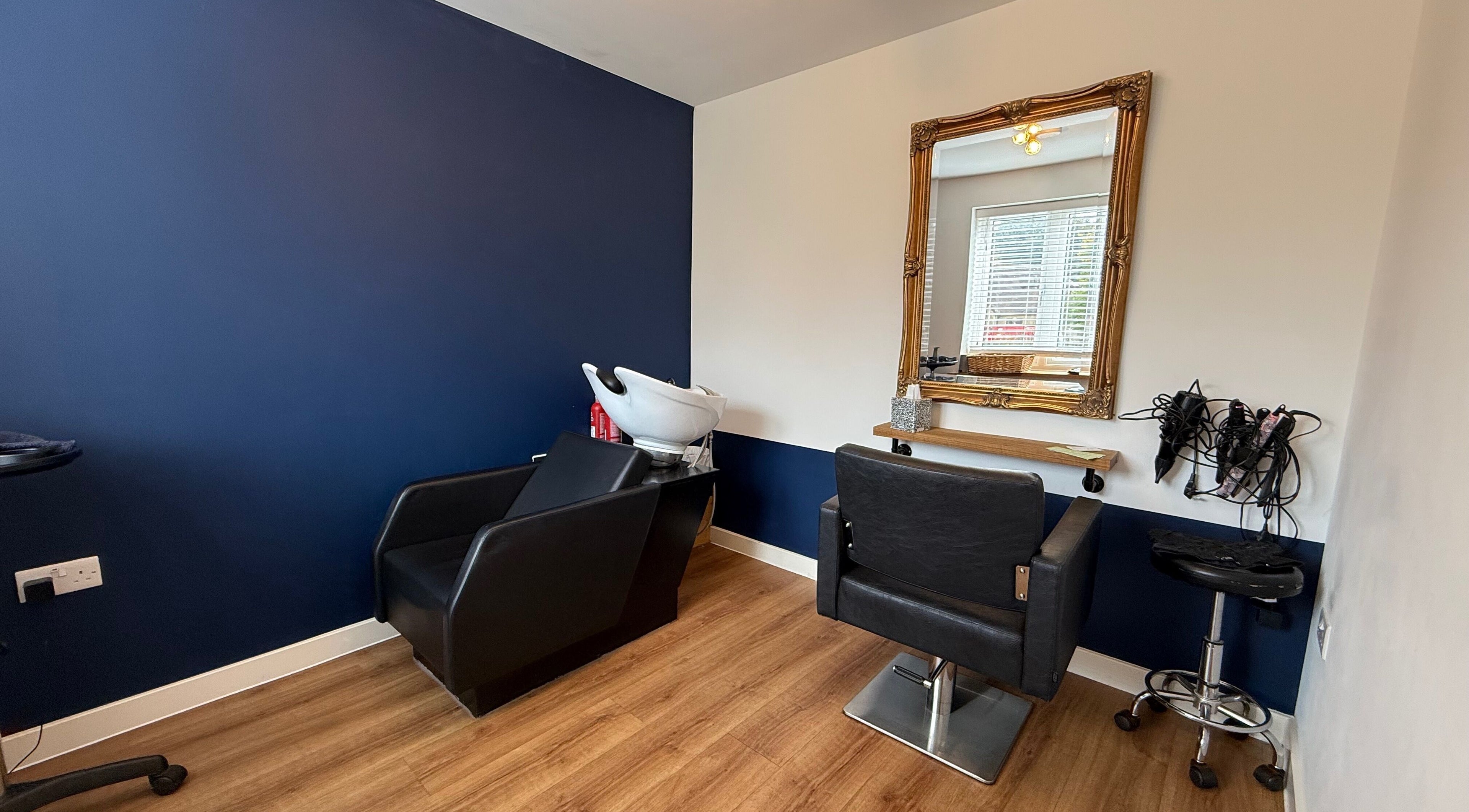 Chic styling station at The Stafford Hair, Shaftesbury, England, GB with mirror and chair.