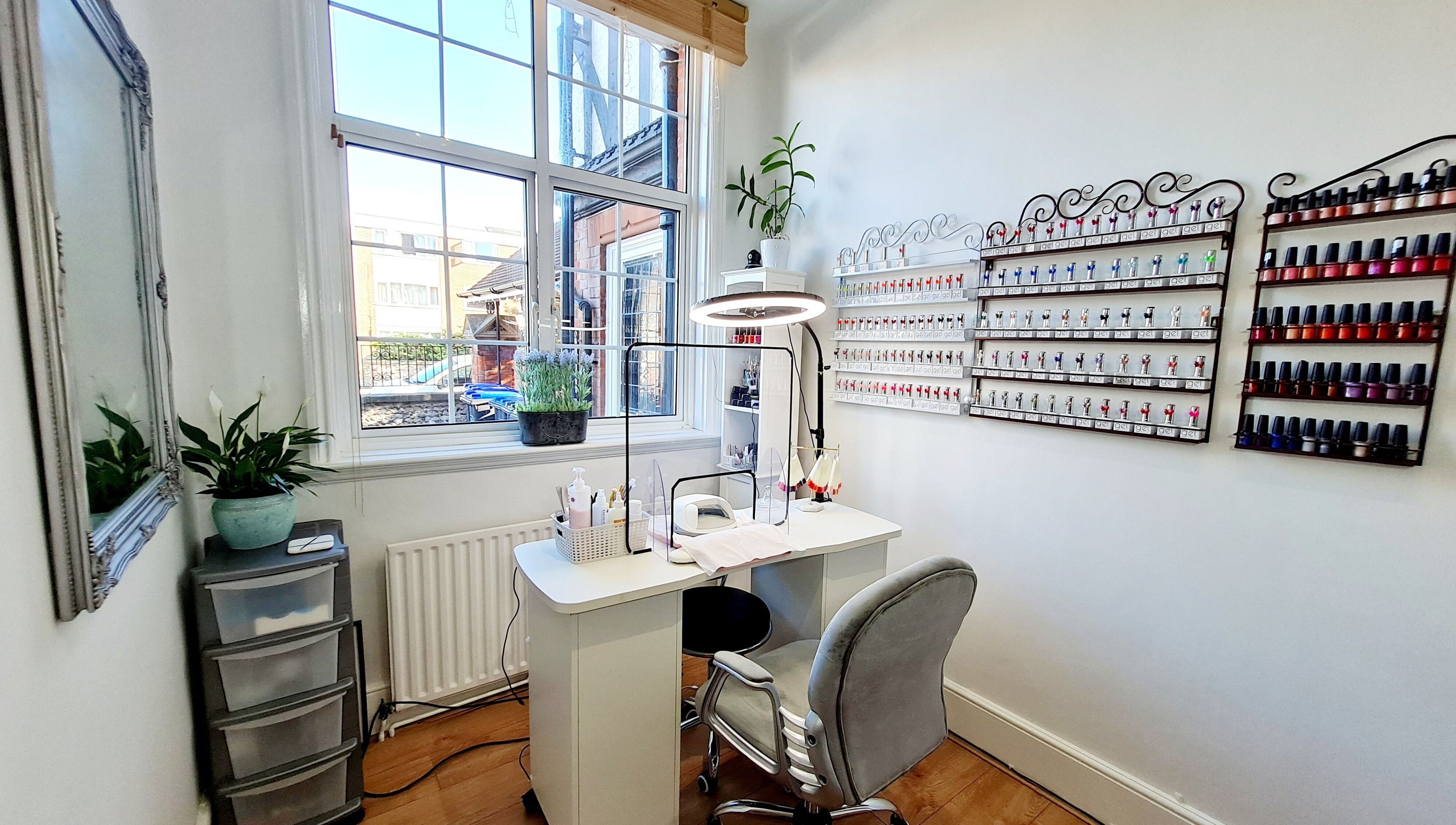 Modern nail station at Fortuna Nails, Worthing, England, GB featuring polish display and sleek furnishings.