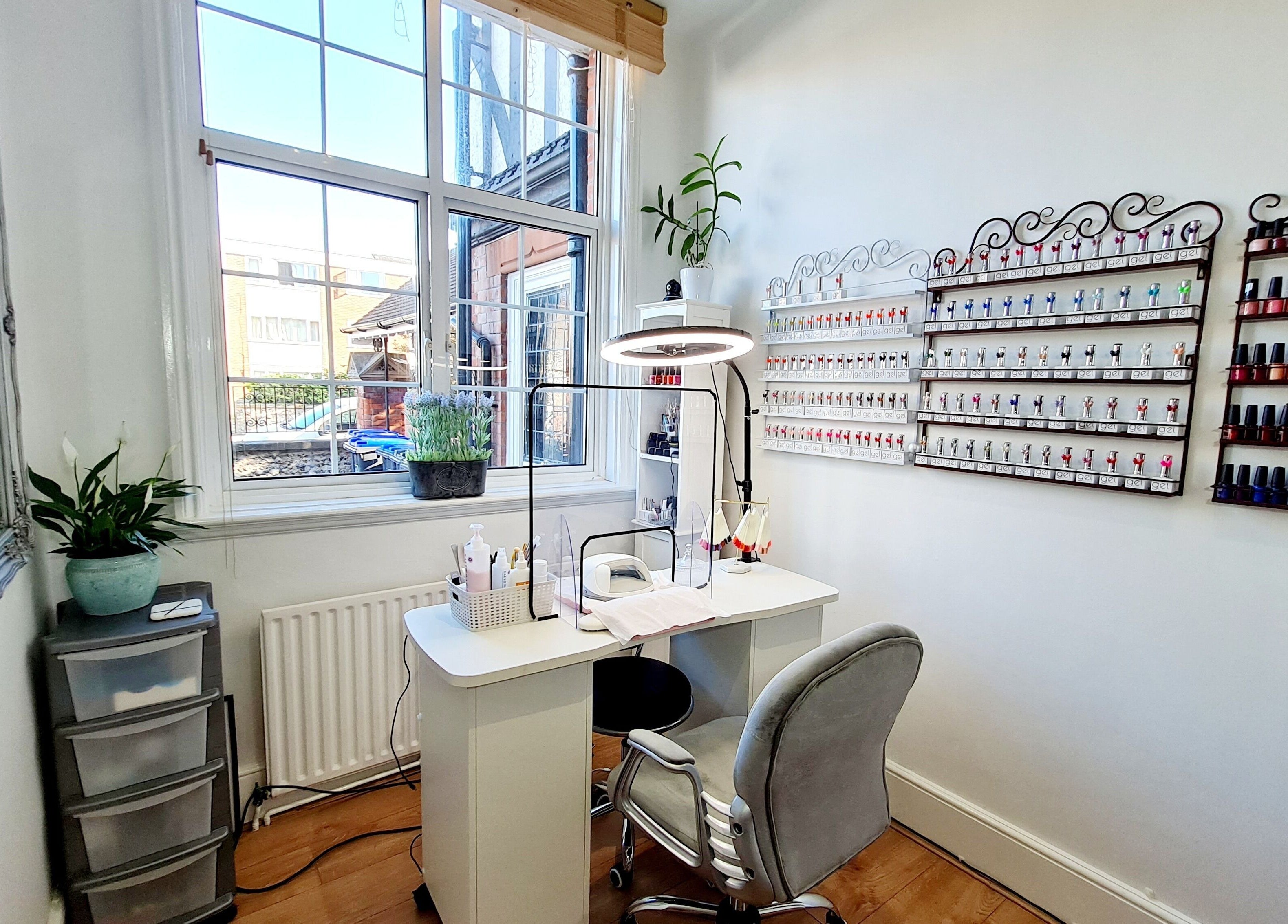 Modern nail station at Fortuna Nails, Worthing, England, GB featuring polish display and sleek furnishings.