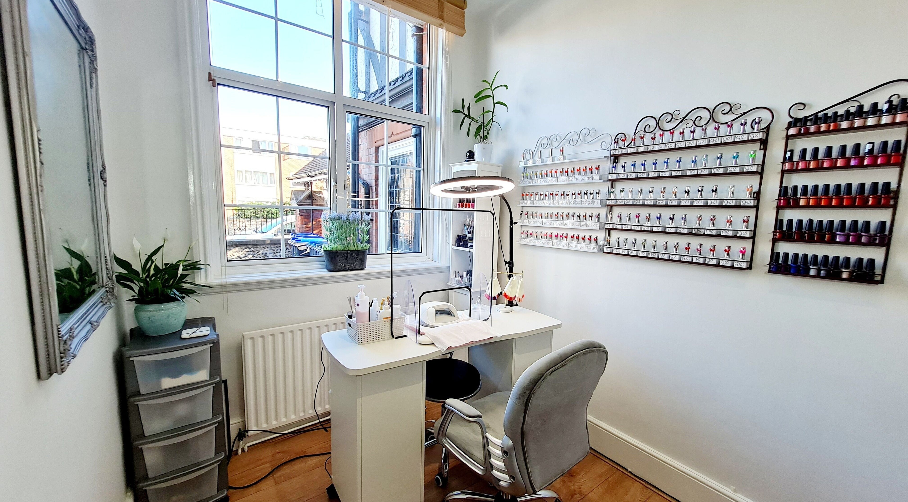 Modern nail station at Fortuna Nails, Worthing, England, GB featuring polish display and sleek furnishings.
