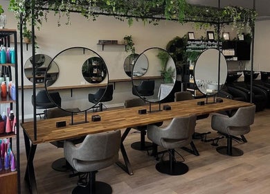 Chic interior of Unique Creations for Hair, Australind, WA with mirrors and styling chairs.