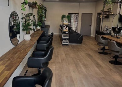 Stylish interior of Unique Creations for Hair in Australind, Western Australia, AU with elegant mirrors and seating.