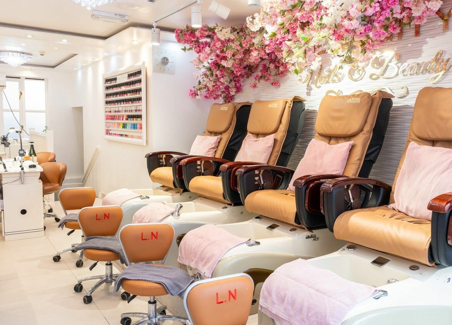 Pedicure spa chairs with floral decor at Serenity Earl's Court, London, England, GB. Experience luxury and comfort.