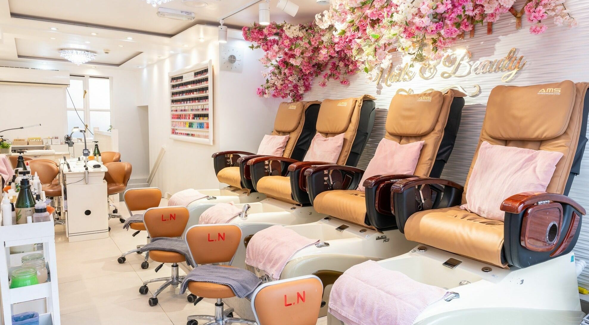 Pedicure spa chairs with floral decor at Serenity Earl's Court, London, England, GB. Experience luxury and comfort.