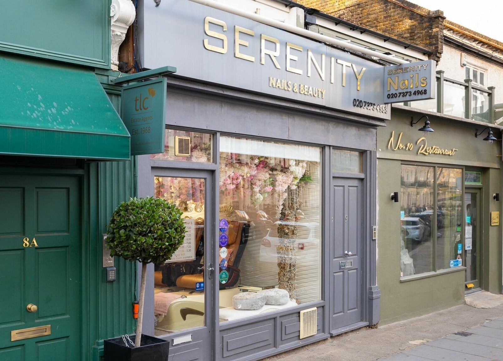 Exterior of Serenity Earl's Court salon in London, England, GB showcasing elegant storefront and signage.