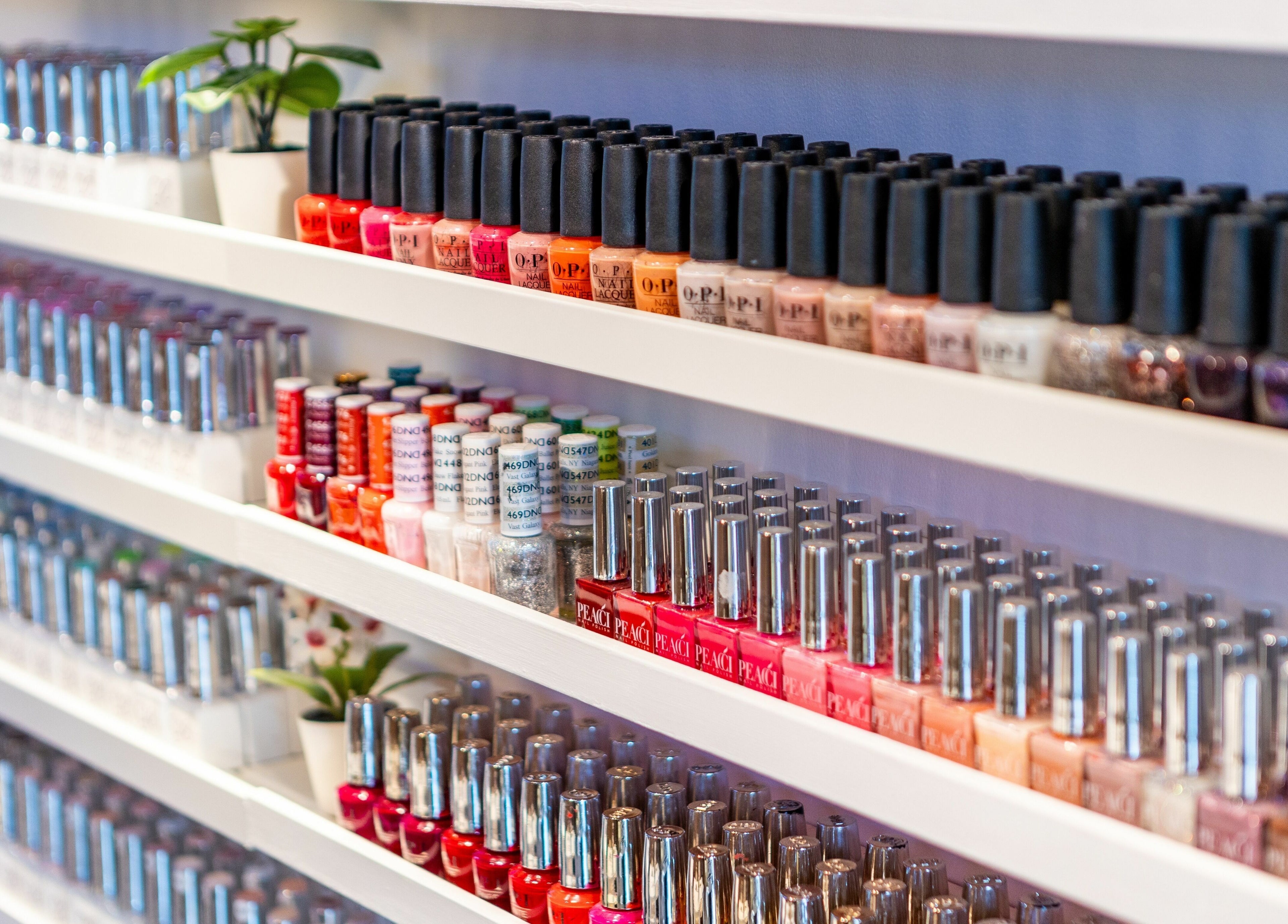 Vibrant nail polish display at Serenity Earl's Court, London, England, GB, showcasing a variety of colors.