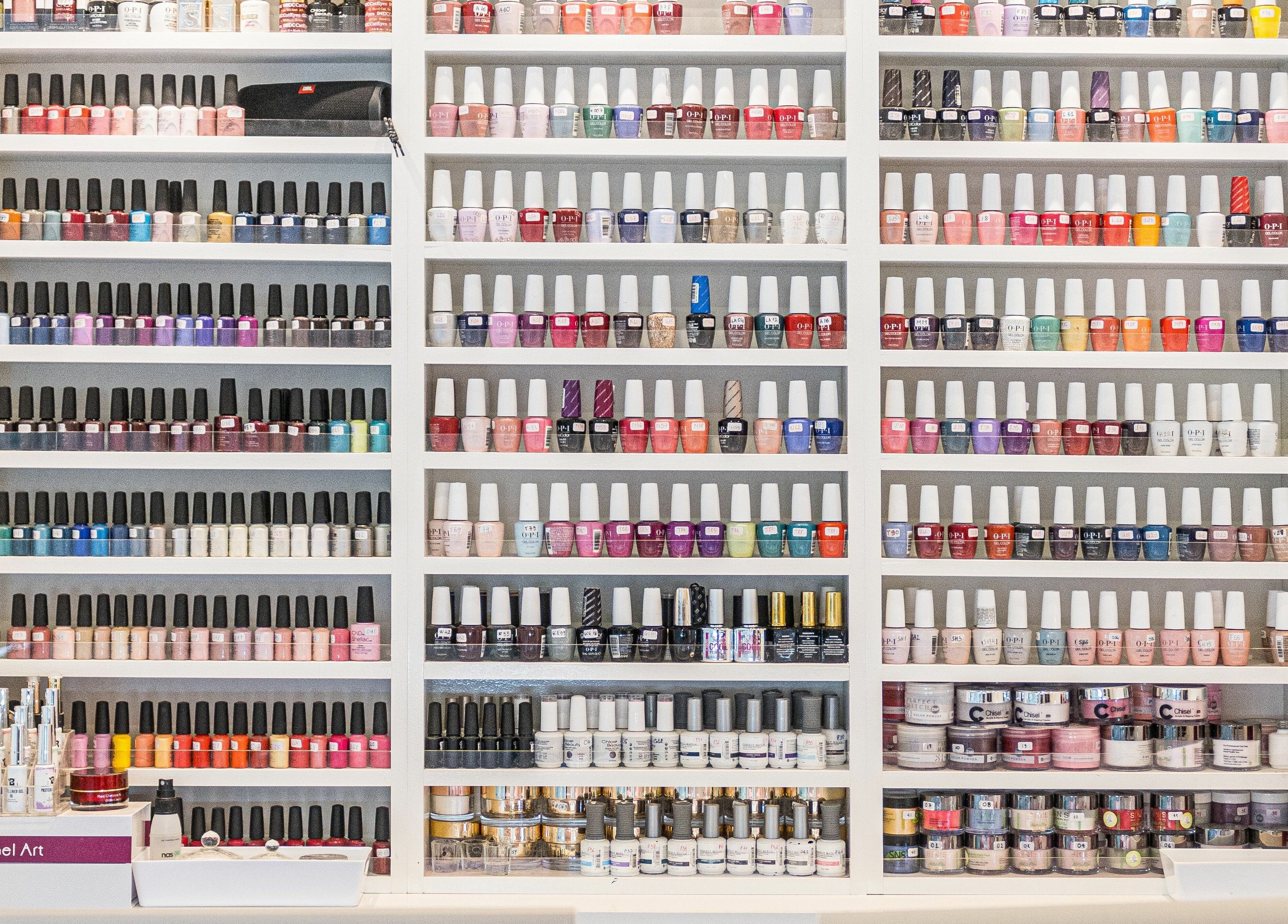Assorted nail polish display at Serenity Holborn, London, England, GB, showcasing vibrant colors.