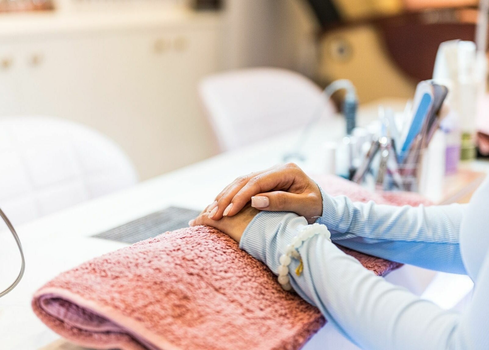 Manicure session at Serenity Holborn, London, England, GB showcasing relaxed hand on towel.