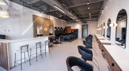 Modern interior of In The Cut Salon, Montréal, Québec, CA, featuring sleek styling stations and seating.