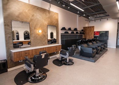Modern salon interior at In The Cut Salon, Montréal, Québec, CA with stylish chairs and mirrors.