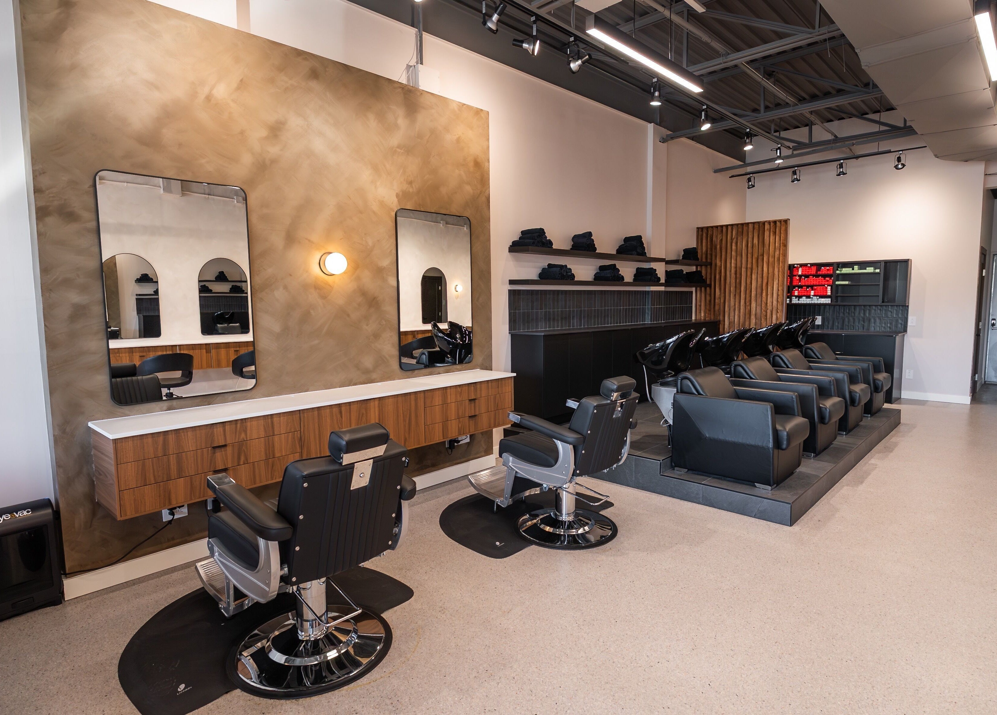 Chic interior of In The Cut Salon, Montréal, Québec, CA. Features sleek styling stations and wash basins.
