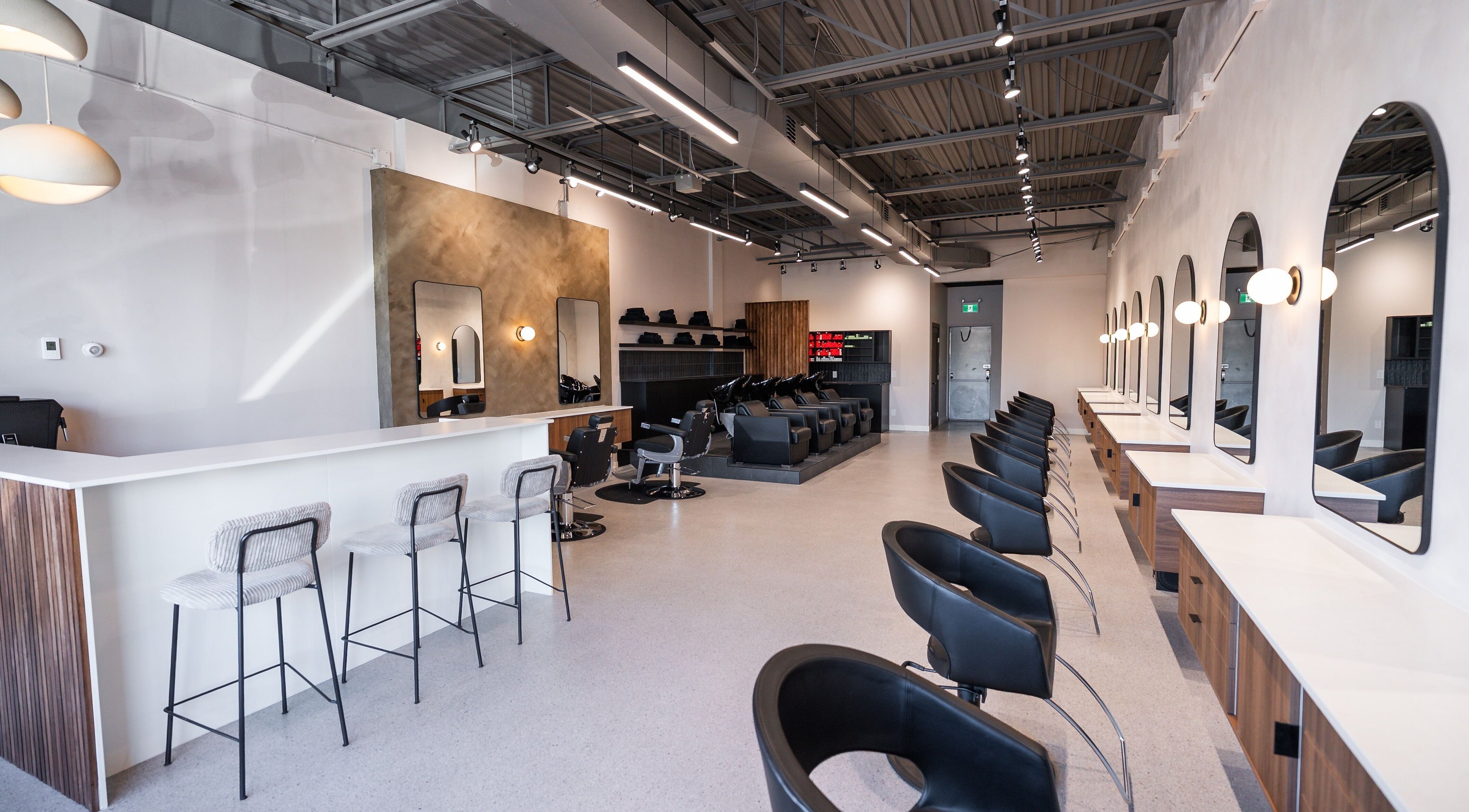 Modern interior of In The Cut Salon in Montréal, Québec, CA, featuring sleek styling stations and chic decor.