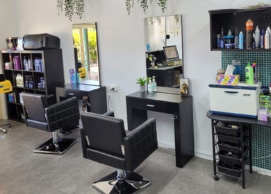 Modern interior of Bring It On Hair salon in Bellmere, Queensland, AU, featuring sleek styling stations and products.