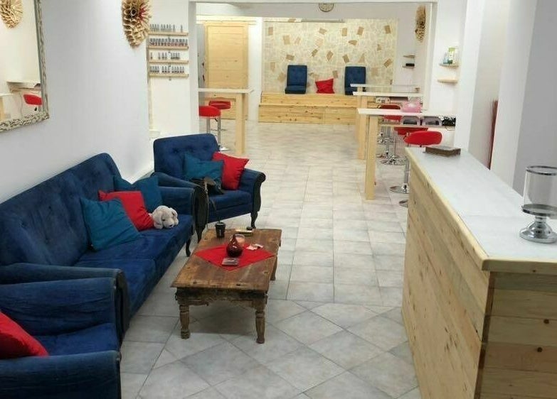 Inviting lounge area at Lucie's Nails and Beauty, Tas-Sliema, MT with cozy blue seating and modern decor.