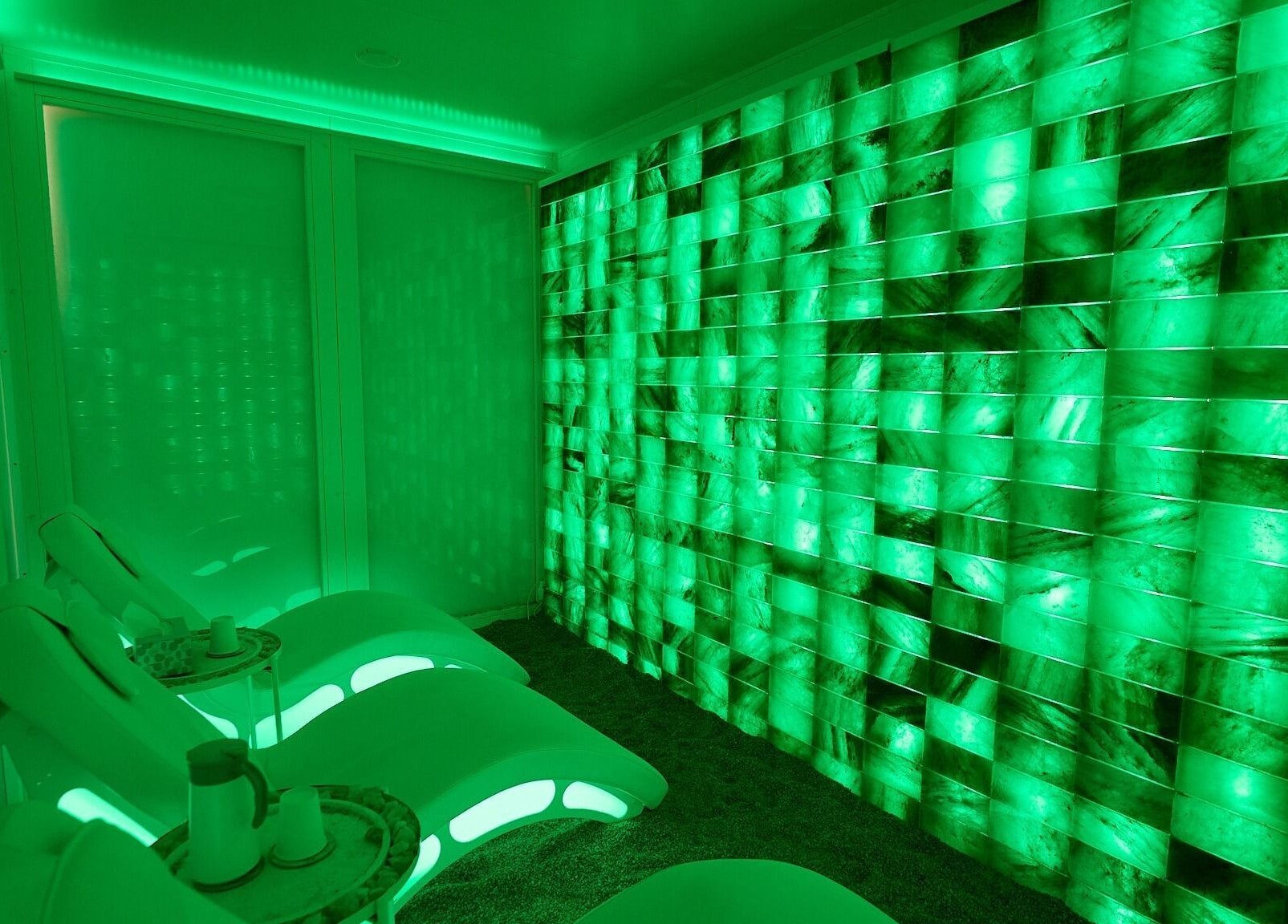 Relaxing emerald-lit room at Cryospa Clinics, Crows Nest, New South Wales, AU emphasizing tranquility and modern design.