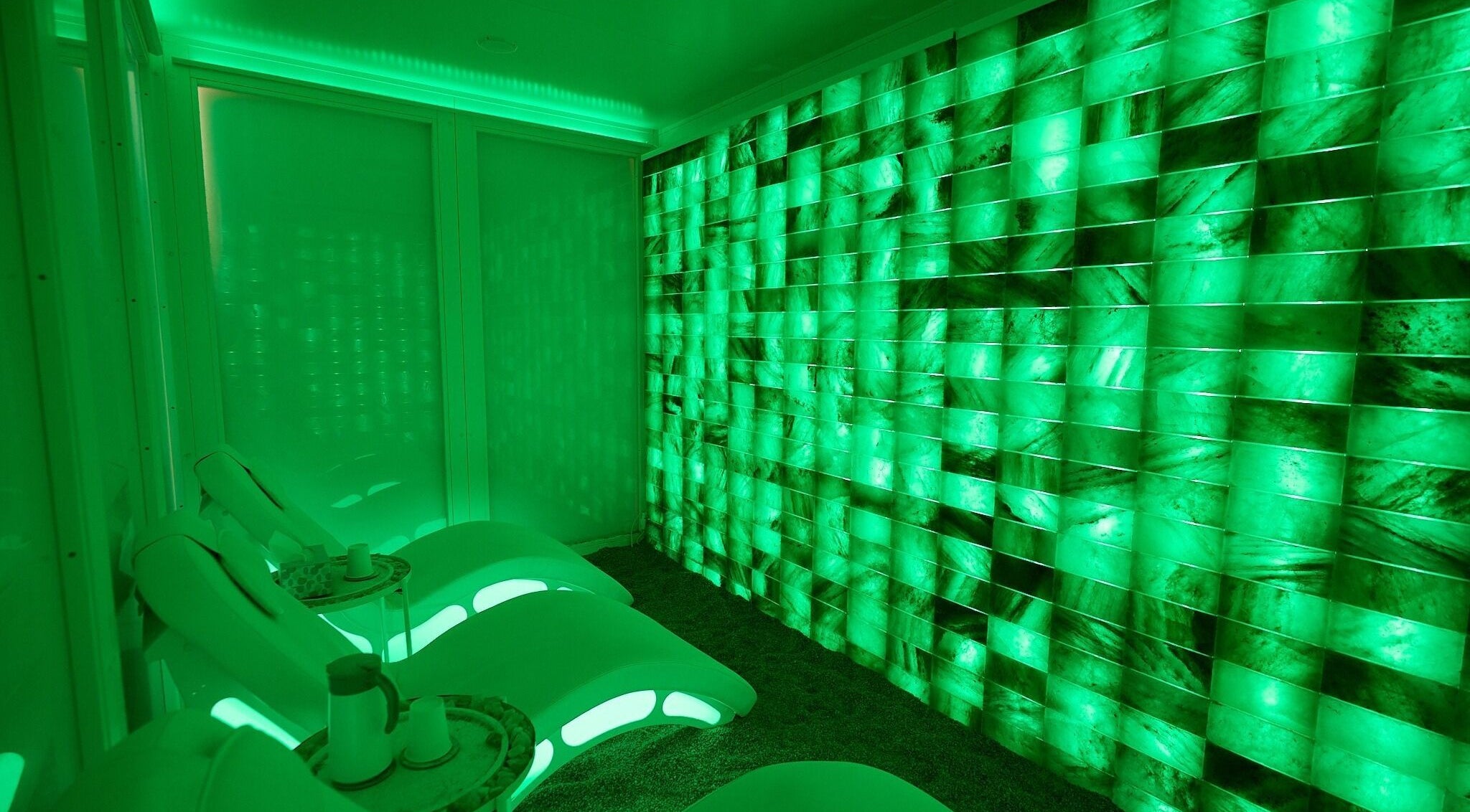 Relaxing emerald-lit room at Cryospa Clinics, Crows Nest, New South Wales, AU emphasizing tranquility and modern design.