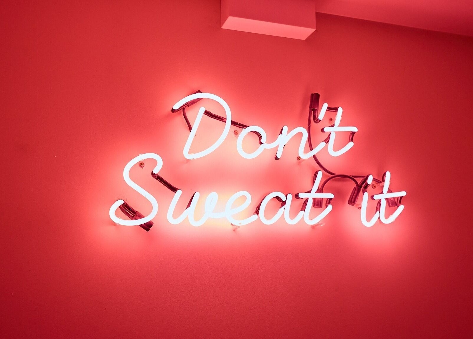 Bright neon sign at Cryospa Clinics, Crows Nest, New South Wales, AU reads 'Don't Sweat It'.