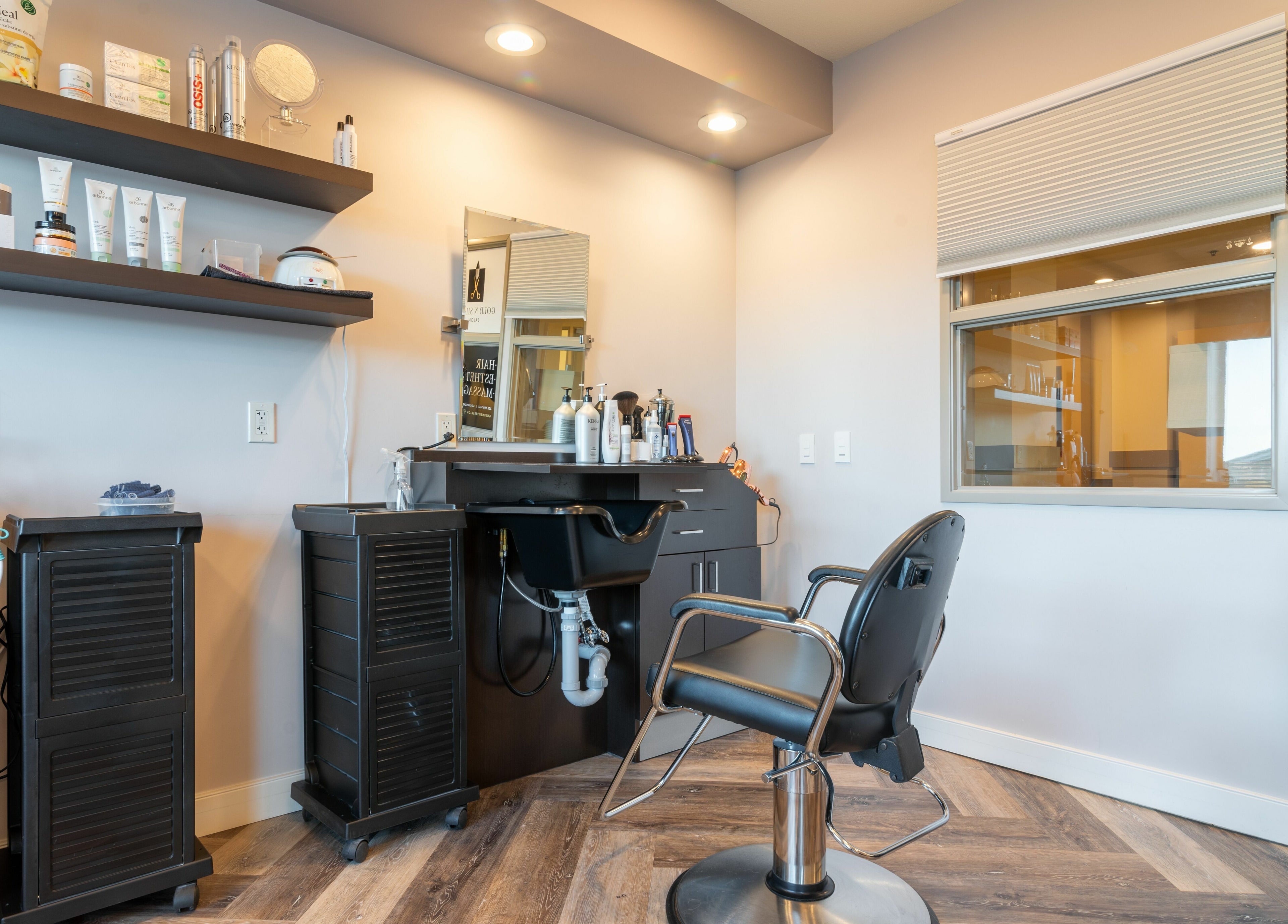 Modern styling area at Gold n Silver Salon, Regina, Saskatchewan, CA featuring salon chair and products.