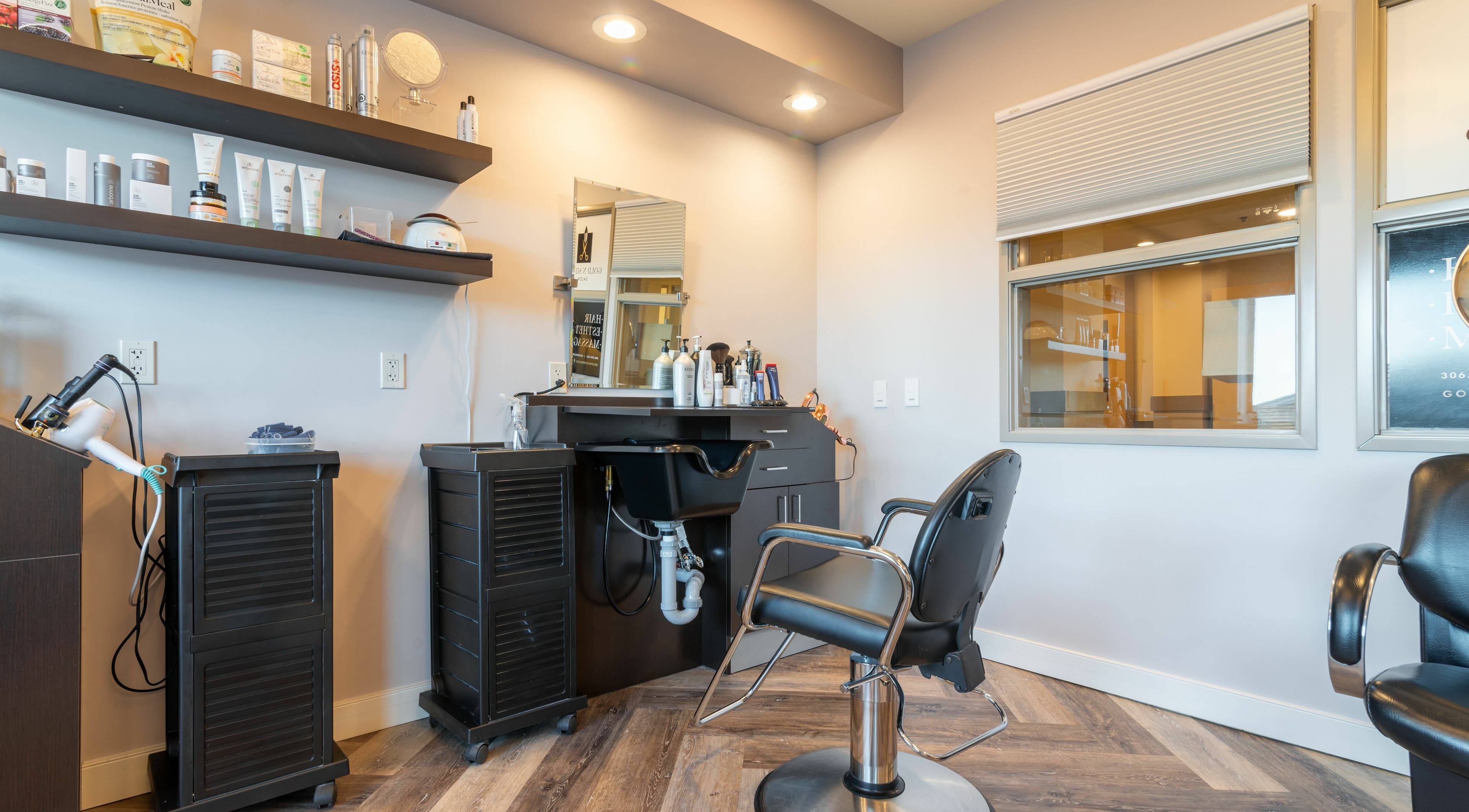 Modern styling area at Gold n Silver Salon, Regina, Saskatchewan, CA featuring salon chair and products.
