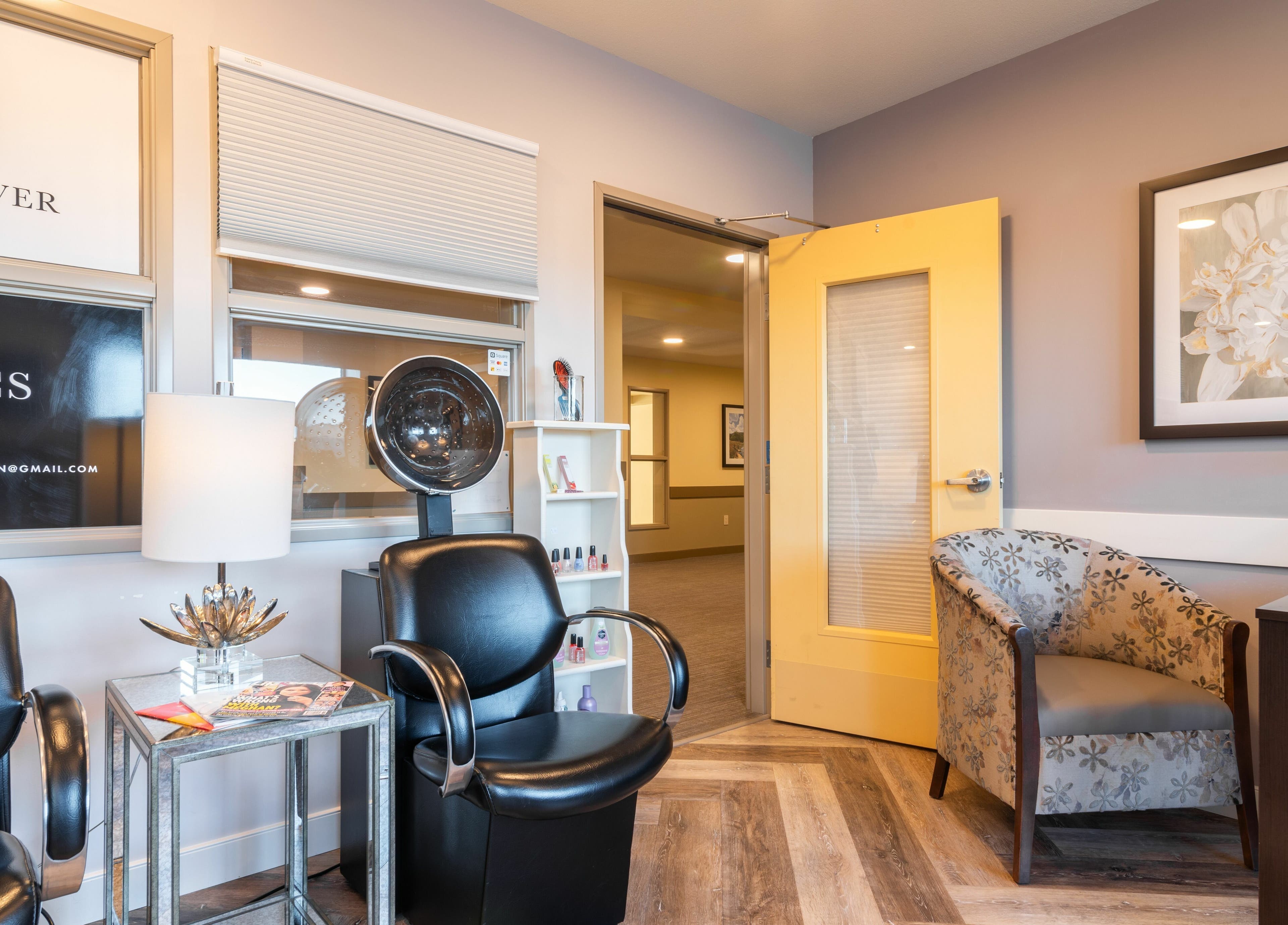 Relaxing seating area at Gold n Silver Salon, Regina, Saskatchewan, CA with plush chairs and chic decor.