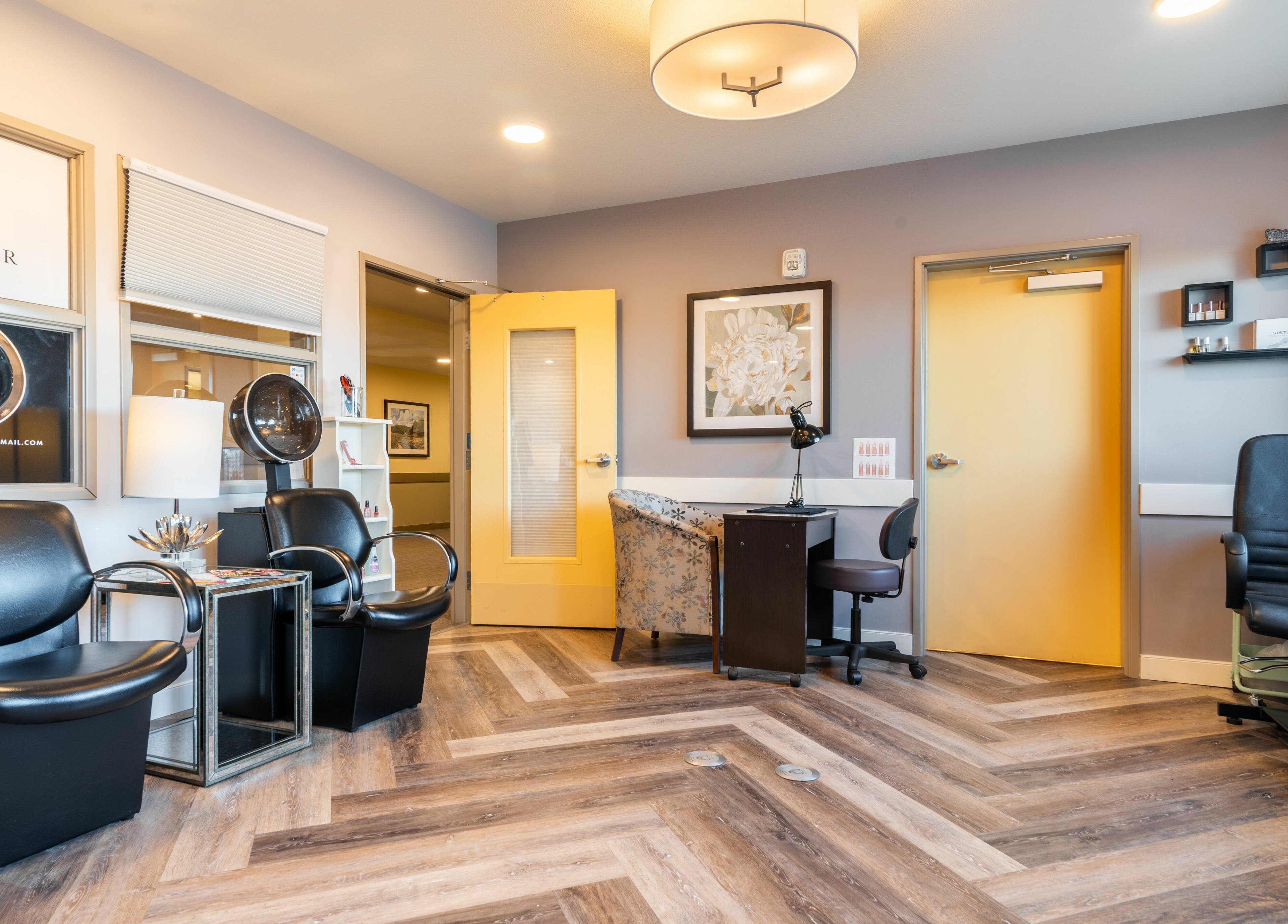 Interior of Gold n Silver Salon, Regina, Saskatchewan, CA showcasing modern chairs and decor.