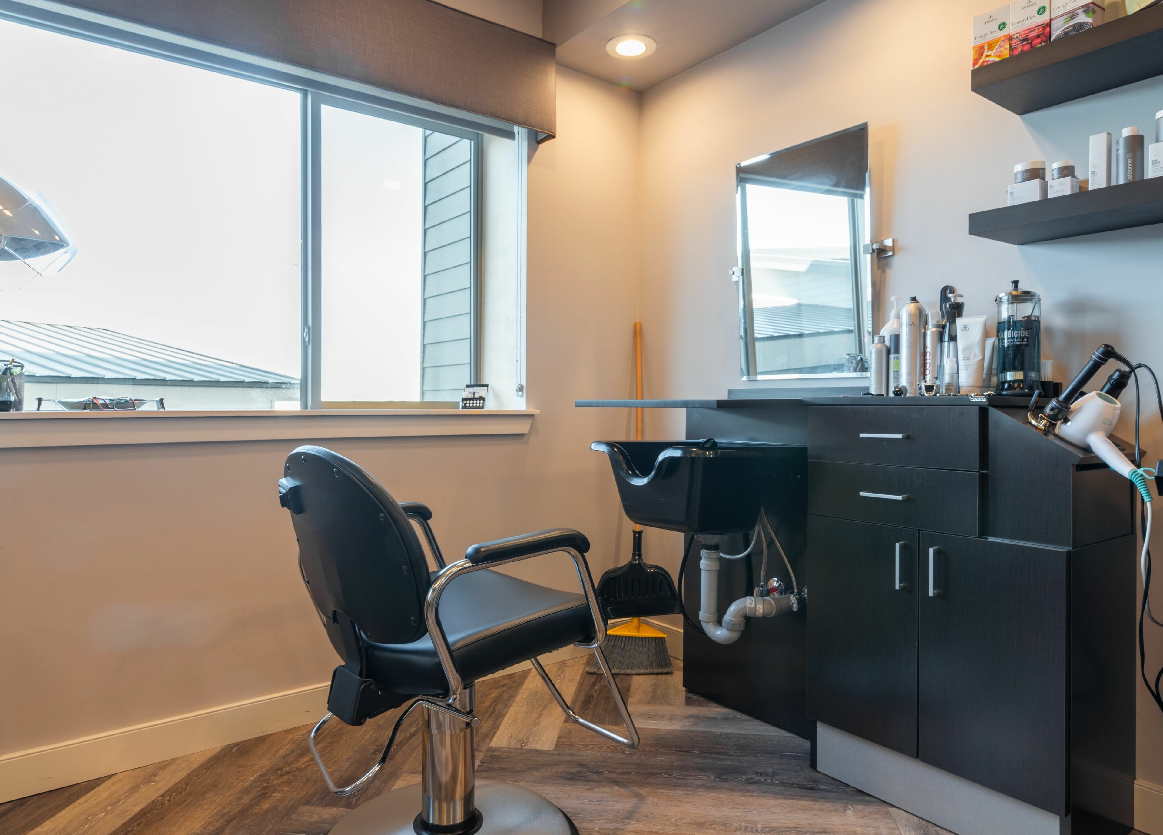 Modern salon station at Gold n Silver Salon, Regina, Saskatchewan, CA featuring stylish chair and hair products.