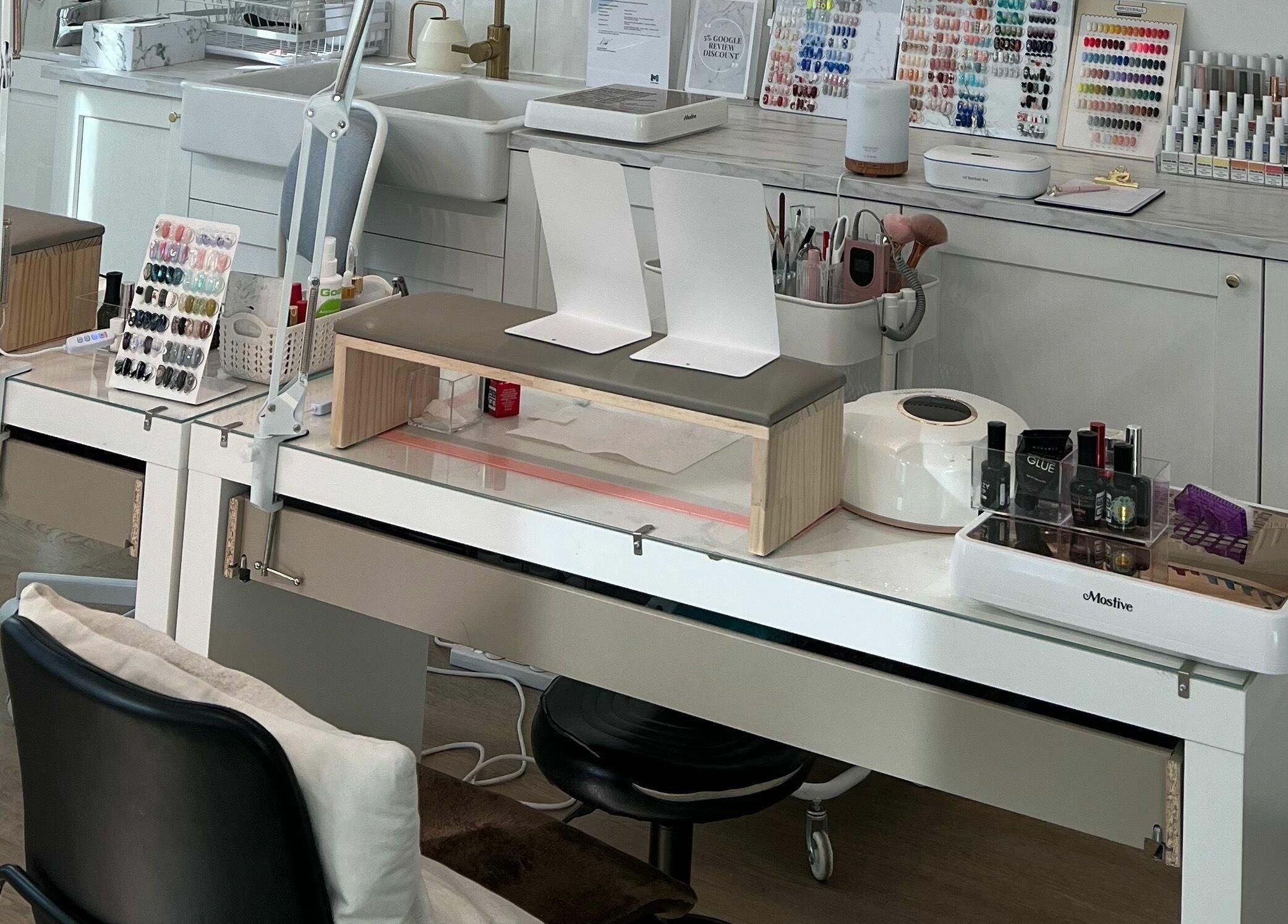 Modern nail station at Beauty Moah in Melbourne, Victoria, AU, showcasing organized polish and tools.