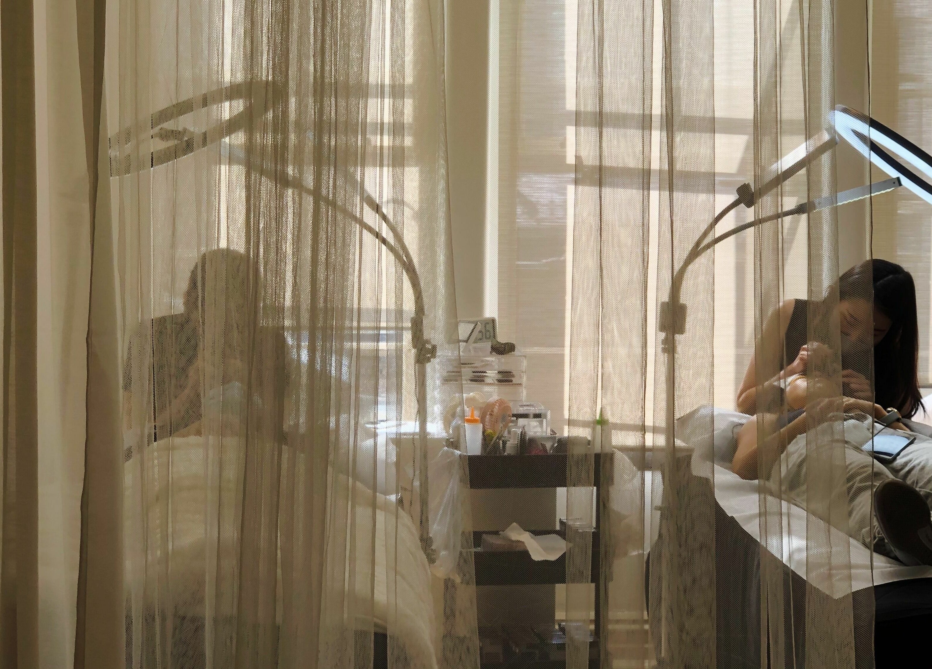 Tranquil spa session behind curtains at Beauty Moah, Melbourne, Victoria, AU, with warm lighting and soothing ambience.