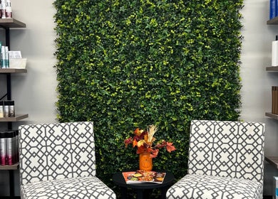 Elegant seating with modern chairs and greenery at Studio K Salon & Spa, Sulphur, Louisiana, US.