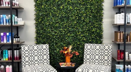 Elegant seating with modern chairs and greenery at Studio K Salon & Spa, Sulphur, Louisiana, US.