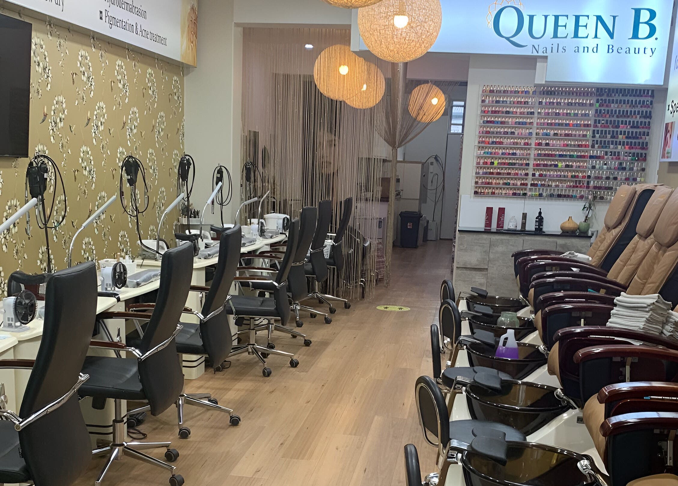 Elegant interior of Queen B Skin and Beauty in Melbourne, Victoria, AU showcasing manicure and pedicure stations.